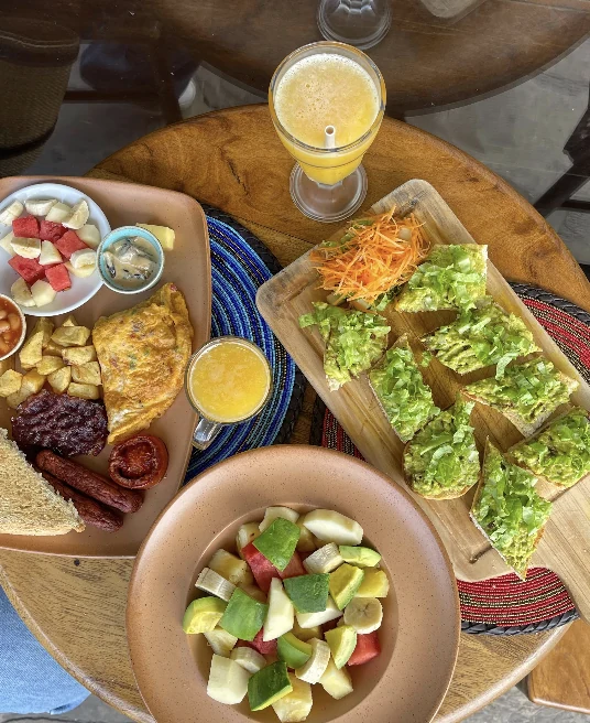 A brunch spread of several plates and fresh juices seen from above