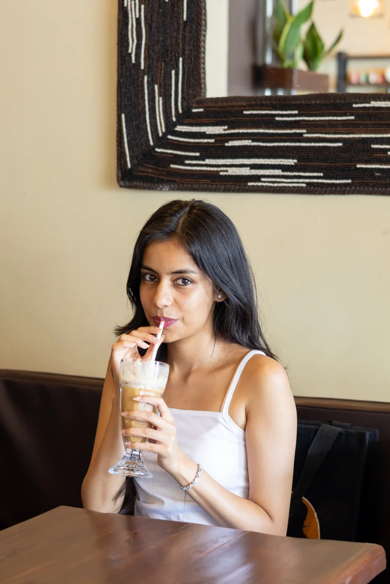 A guest enjoying an iced coffee in the café