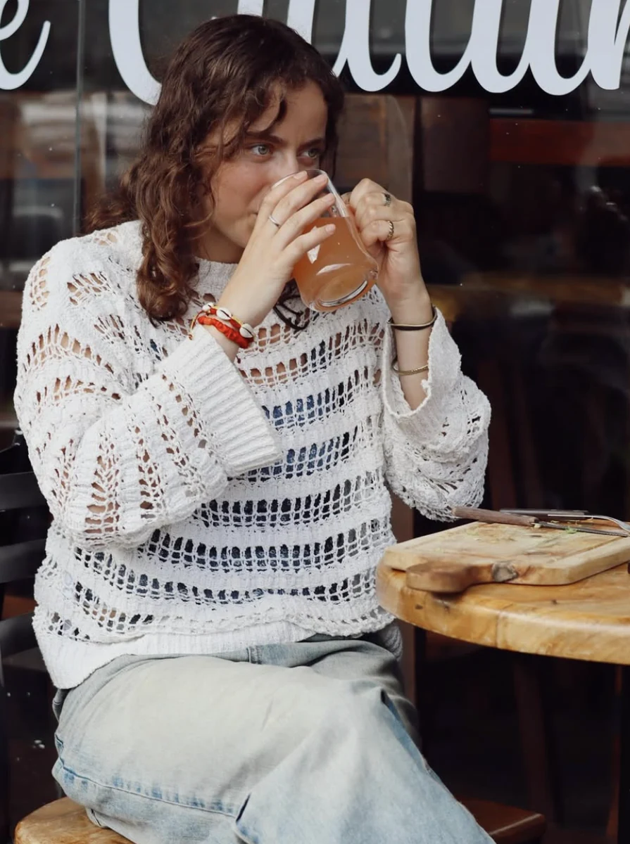 A guest enjoying a cold drink by the window of the café