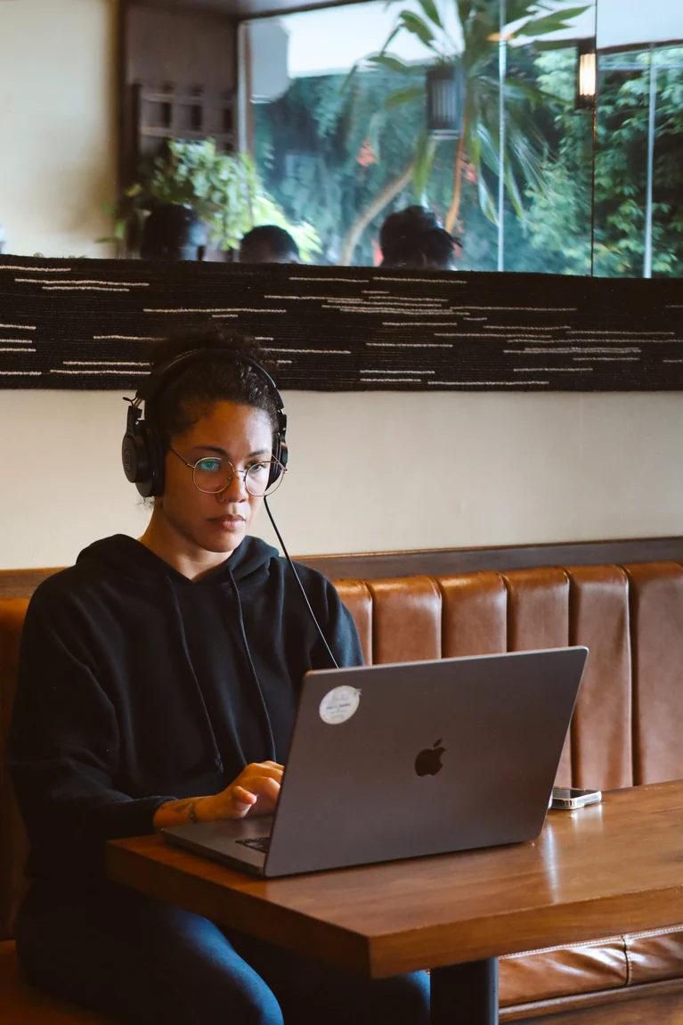 A guest working on a laptop by the window