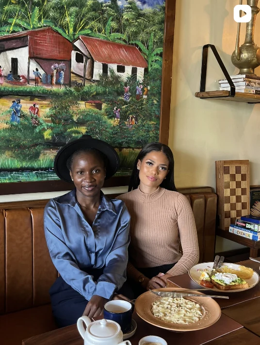 Guests sharing a meal at Coffee Culture beneath the painted wall art