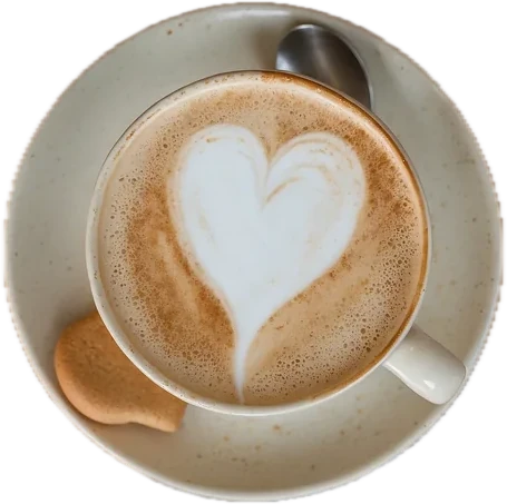 An overhead cappuccino with heart latte art on a saucer